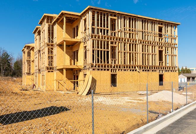 a close-up of temporary chain link fences enclosing a job site, signaling progress in the project's development in West Townsend